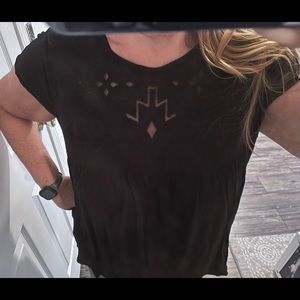Casual studio, black T-shirt with Aztec cut out styling on the collar